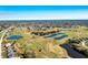 Expansive aerial view of golf course and surrounding neighborhood at 217 Rotonda Cir, Rotonda West, FL 33947