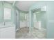 Double vanity bathroom with marble shower and tiled floors at 217 Rotonda Cir, Rotonda West, FL 33947