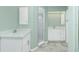 Clean bathroom with white cabinets and tiled shower at 217 Rotonda Cir, Rotonda West, FL 33947