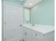 Simple bathroom with white vanity and a view of a door at 217 Rotonda Cir, Rotonda West, FL 33947