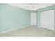 Light green bedroom with tile floors and double door closet at 217 Rotonda Cir, Rotonda West, FL 33947