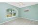 Bedroom with large window, tile flooring, and ceiling fan at 217 Rotonda Cir, Rotonda West, FL 33947