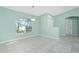 Bright dining room with tile floors and a large arched window at 217 Rotonda Cir, Rotonda West, FL 33947