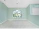 Bright dining room with tile floors and a large arched window at 217 Rotonda Cir, Rotonda West, FL 33947