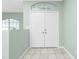 Interior view of double doors and sage green walls at 217 Rotonda Cir, Rotonda West, FL 33947