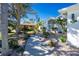 Landscaped front yard with a walkway at 217 Rotonda Cir, Rotonda West, FL 33947