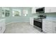Kitchen with stainless steel appliances and white cabinets at 217 Rotonda Cir, Rotonda West, FL 33947
