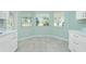 Modern kitchen with white cabinets, stainless steel appliances and tile floors at 217 Rotonda Cir, Rotonda West, FL 33947
