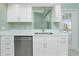 Modern kitchen with white cabinets, stainless steel appliances, and tile floors at 217 Rotonda Cir, Rotonda West, FL 33947