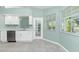 Modern kitchen with white cabinets, stainless steel appliances and tile floors at 217 Rotonda Cir, Rotonda West, FL 33947
