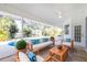 Relaxing covered lanai overlooking the pool at 217 Rotonda Cir, Rotonda West, FL 33947