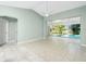 Living room with tile floors and sliding glass doors to the pool at 217 Rotonda Cir, Rotonda West, FL 33947