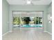 Living room with tile floors and sliding glass doors to the pool at 217 Rotonda Cir, Rotonda West, FL 33947