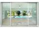 Living room with sliding glass doors that open to the pool area at 217 Rotonda Cir, Rotonda West, FL 33947