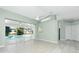 Spacious living room with tile floors and sliding glass doors leading to the pool at 217 Rotonda Cir, Rotonda West, FL 33947