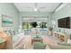 Bright living room with pool view, comfy seating, and large TV at 217 Rotonda Cir, Rotonda West, FL 33947