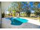 Private, kidney-shaped pool surrounded by lush landscaping at 217 Rotonda Cir, Rotonda West, FL 33947