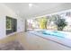 Covered patio overlooks refreshing pool with easy access from sliding glass doors at 217 Rotonda Cir, Rotonda West, FL 33947
