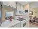 Eat-in kitchen with electric range, microwave, and view into dining area at 23 Quails Run Blvd # 2, Englewood, FL 34223