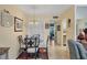 Charming dining area with glass table and four chairs, near kitchen at 23 Quails Run Blvd # 2, Englewood, FL 34223