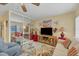 Relaxing living room featuring a large TV and comfortable seating at 23 Quails Run Blvd # 2, Englewood, FL 34223