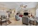 Bright living room with comfy seating and a large TV at 23 Quails Run Blvd # 2, Englewood, FL 34223