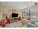 Bright living room featuring a comfy sofa and large TV at 23 Quails Run Blvd # 2, Englewood, FL 34223