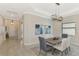 Bright dining room with a wood table, neutral walls, and modern light fixture at 25122 Spartina Dr, Venice, FL 34293