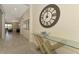 Open hallway with a large clock and view into living area at 25122 Spartina Dr, Venice, FL 34293