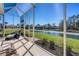 Relaxing screened-in patio with pond view at 29705 Niagara Ct, Englewood, FL 34223