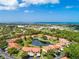 Beautiful aerial view of the community showcasing the lush landscaping, serene pond, and nearby ocean at 404 Pine Hollow Cir # 404, Englewood, FL 34223