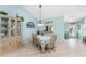 Bright dining room with a hutch, table with seating for six, and a view into the kitchen at 404 Pine Hollow Cir # 404, Englewood, FL 34223
