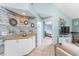 Hallway with coastal-themed decor, connecting the living area to the bedroom at 404 Pine Hollow Cir # 404, Englewood, FL 34223