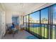Enclosed lanai with serene view of the pond and lush landscaping at 404 Pine Hollow Cir # 404, Englewood, FL 34223