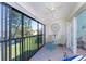 Relaxing lanai with sliding glass doors and views of the lush green landscaping and tranquil water at 404 Pine Hollow Cir # 404, Englewood, FL 34223