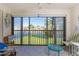 Relaxing screened lanai with seating area overlooking a pond and landscaped grounds at 404 Pine Hollow Cir # 404, Englewood, FL 34223