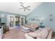 Comfortable living room with french doors leading to a screened lanai and peaceful views at 404 Pine Hollow Cir # 404, Englewood, FL 34223