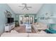 Bright living room with coastal-themed decorations, ceiling fan and view of the lanai at 404 Pine Hollow Cir # 404, Englewood, FL 34223