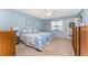 Comfortable main bedroom with blue walls, a window, and a door to the outside at 404 Pine Hollow Cir # 404, Englewood, FL 34223
