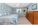 Comfortable main bedroom with blue walls, a window, and ample space for furnishings at 404 Pine Hollow Cir # 404, Englewood, FL 34223