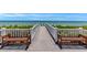 Walkway to the beach with benches offering serene ocean views at 5000 Gasparilla Rd # Dc206, Boca Grande, FL 33921