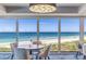 Enjoy ocean views from this elegant dining area, featuring a round table and comfortable chairs at 5000 Gasparilla Rd # Dc206, Boca Grande, FL 33921