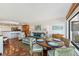 Open-concept living space with terracotta floors and a view of the kitchen and dining area at 5000 Gasparilla Rd # Dc206, Boca Grande, FL 33921