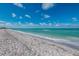 White sand beach with calm ocean water and blue sky at 5000 Gasparilla Rd # Dc206, Boca Grande, FL 33921