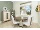 Elegant breakfast nook with a round table and four chairs near a window at 65 Par View Ter, Rotonda West, FL 33947