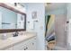 Bathroom featuring a framed mirror and a shower with a colorful shower curtain at 6800 Placida Rd # 207, Englewood, FL 34224