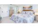 Bright bedroom features a wicker headboard, soft blue walls, and beach-themed art at 6800 Placida Rd # 207, Englewood, FL 34224