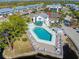 Aerial view of the community pool with chairs and tables ready for relaxing at 6800 Placida Rd # 207, Englewood, FL 34224