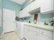 Laundry room with white cabinets, washer, dryer, and utility sink at 848 Boundary Blvd, Rotonda West, FL 33947