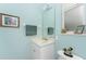 Small bathroom with light blue walls and marble vanity at 848 Boundary Blvd, Rotonda West, FL 33947